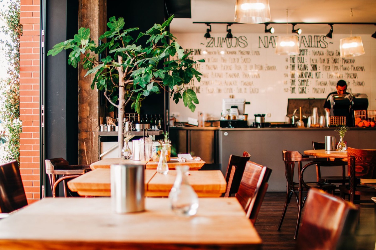 Ramen shop interior with white walls and wooden tables