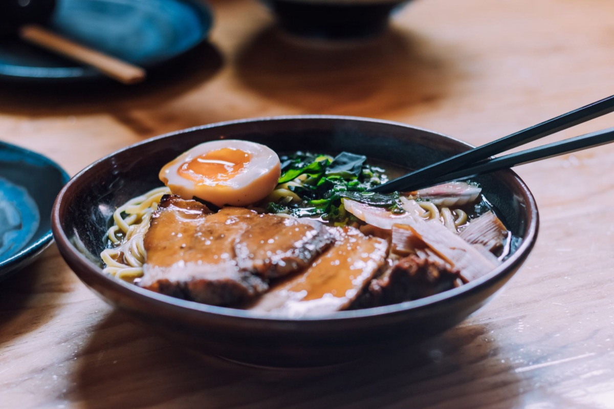 Ramen noodles in broth with green vegetables