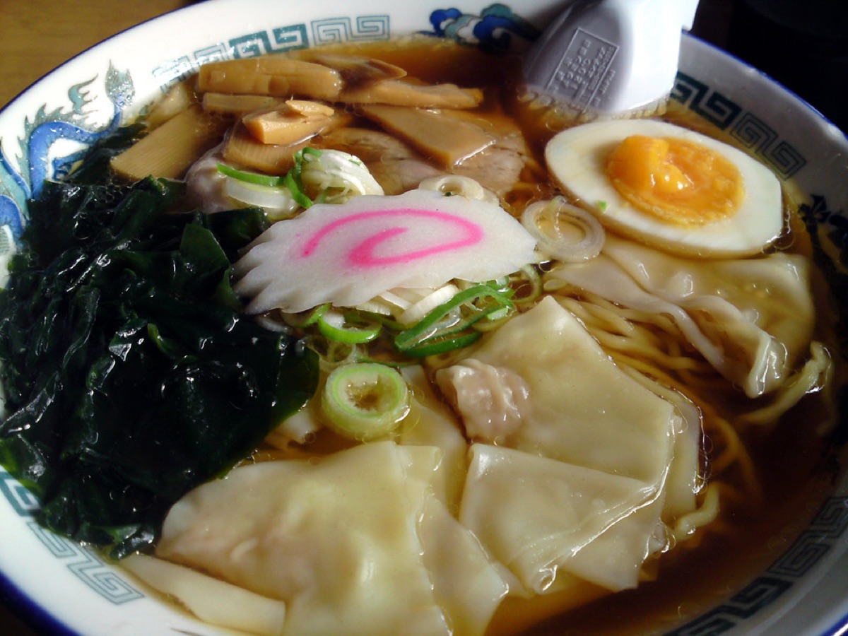 Close-up of a steaming ramen soup bowl with noodles, broth, and vegetables