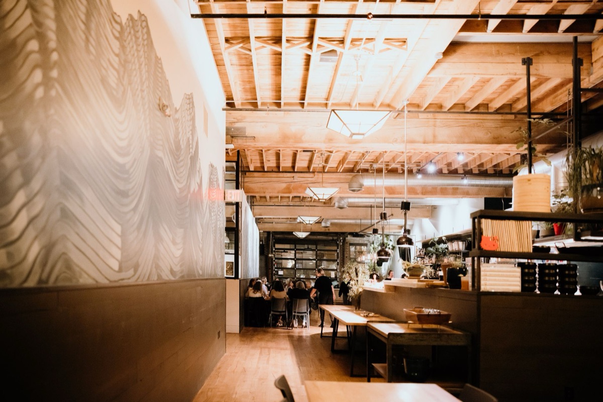 ramen shop interior with white walls and wooden tables
